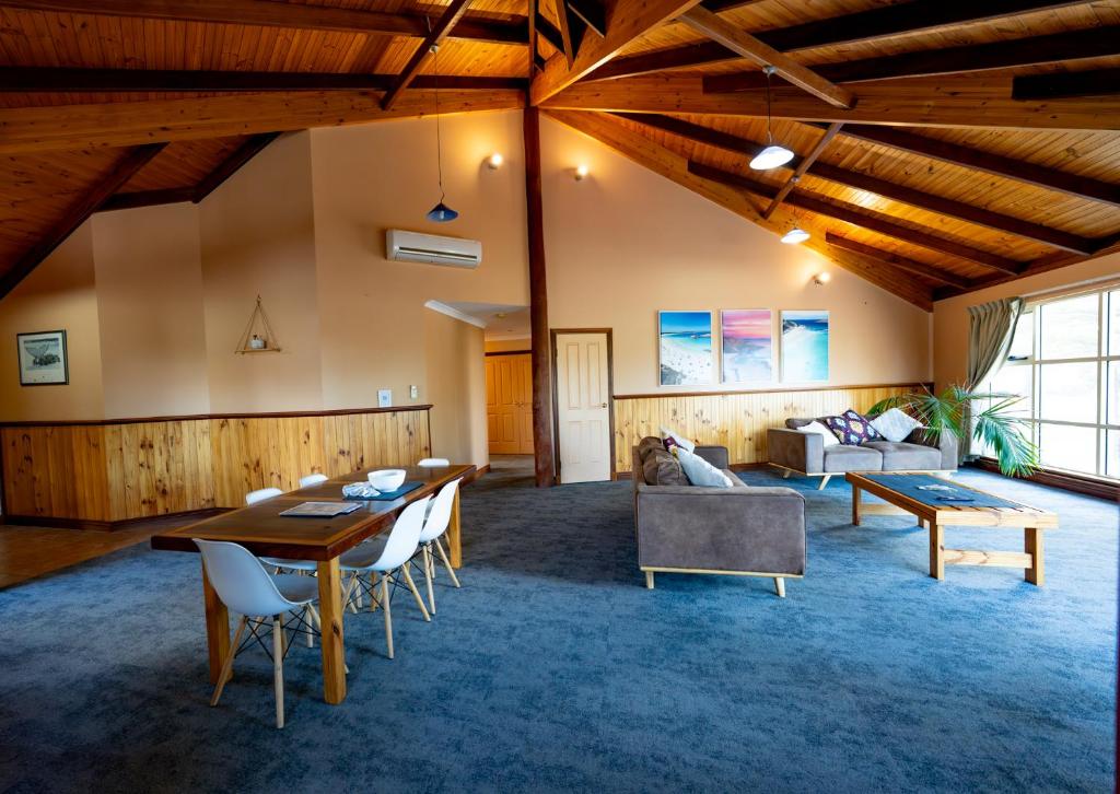 a living room with a table and a couch at Esperance Foreshore Apartments in Esperance