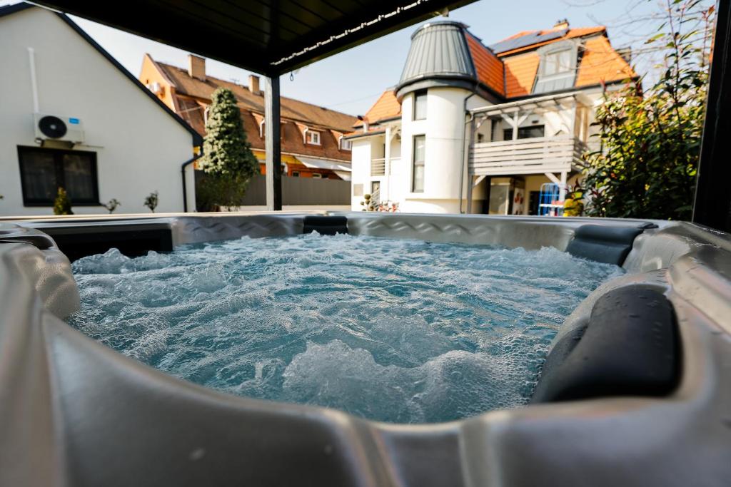 a hot tub with water in it in a backyard at Lumen Gasztropanzió in Eger