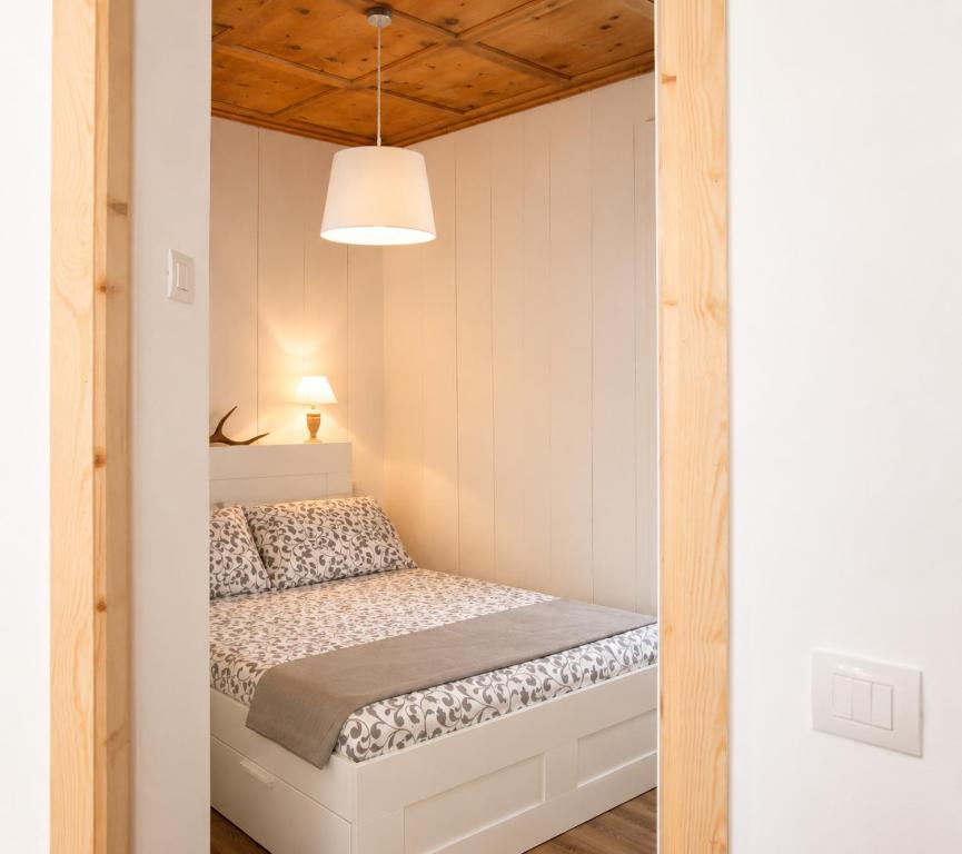 a bedroom with a bed in a small room at nel cuore di Bormio in Bormio
