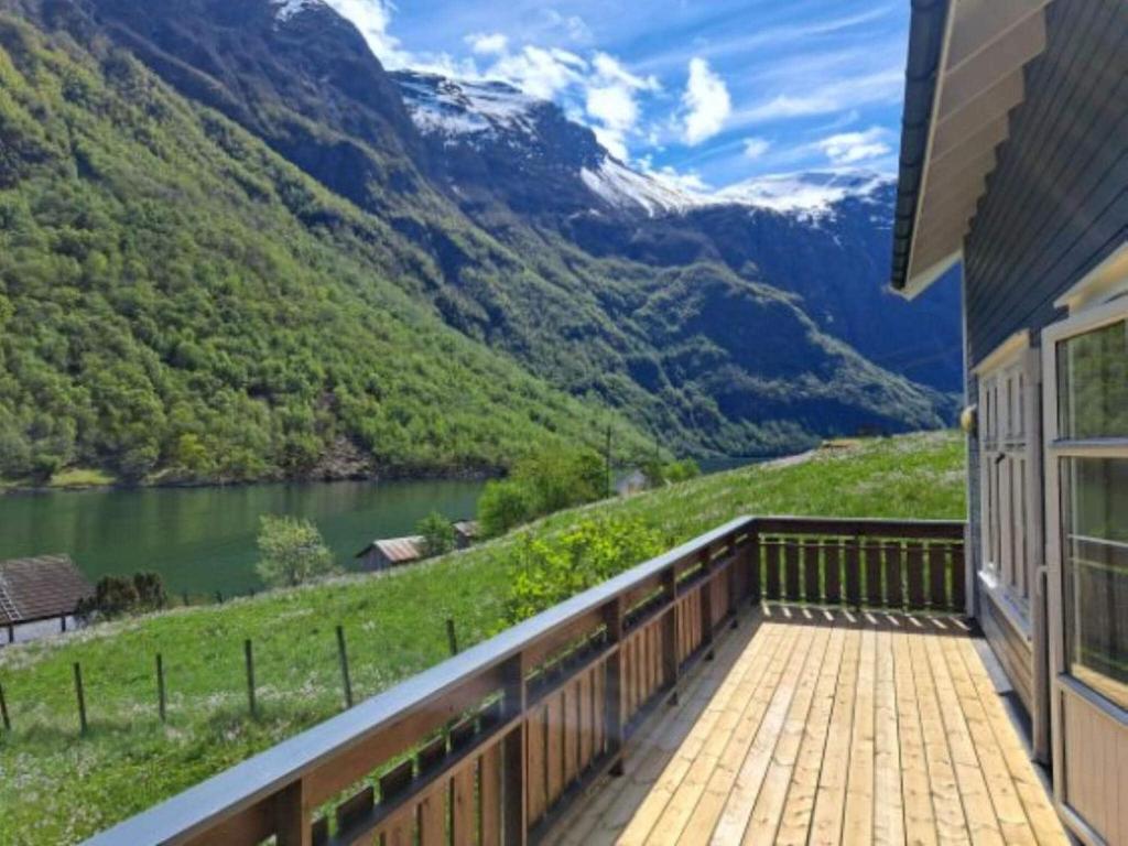 a balcony with a view of a river and mountains at 6 person holiday home in Gudvangen-By Traum in Gudvangen