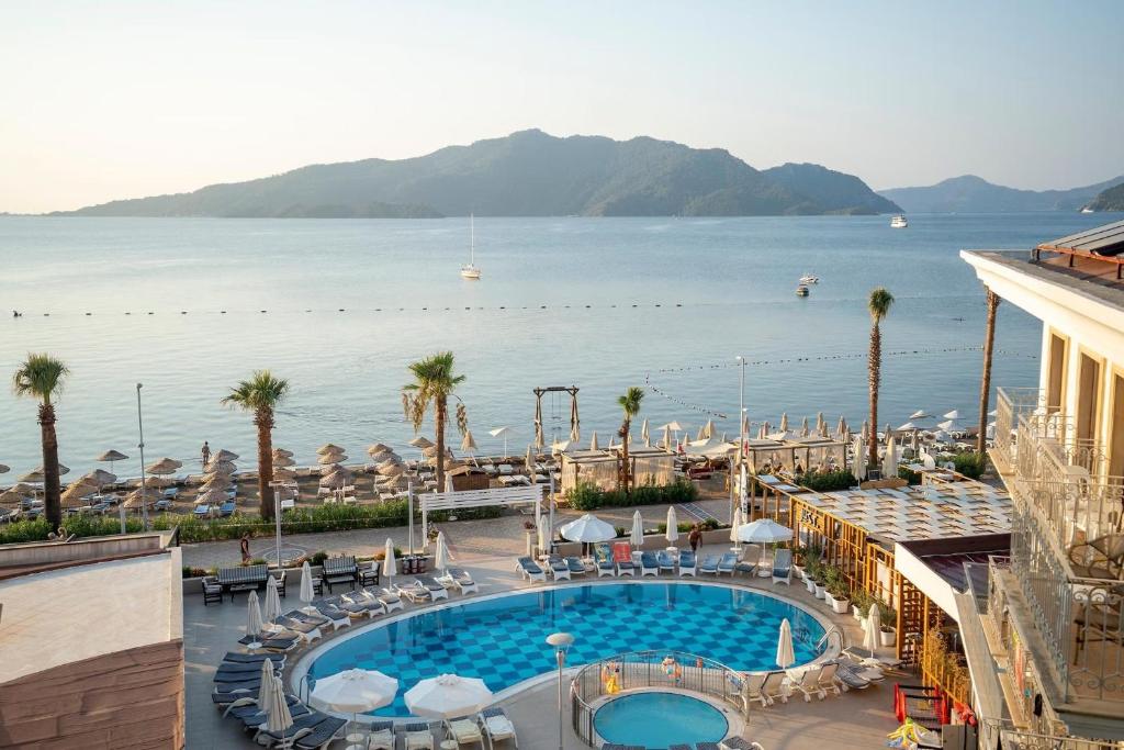 a hotel with a pool and a view of the water at Pasa Garden Beach in Marmaris