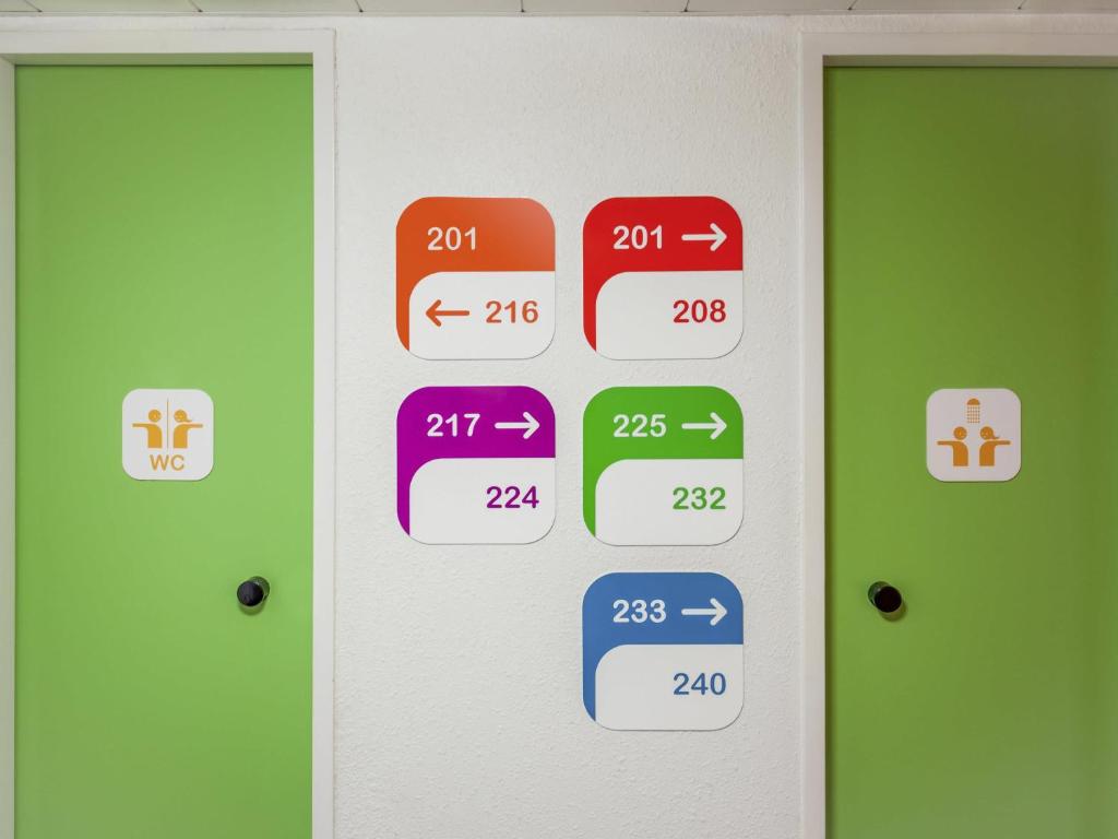a room with two doors with different signs on them at hotelF1 Epinal Nord in Épinal