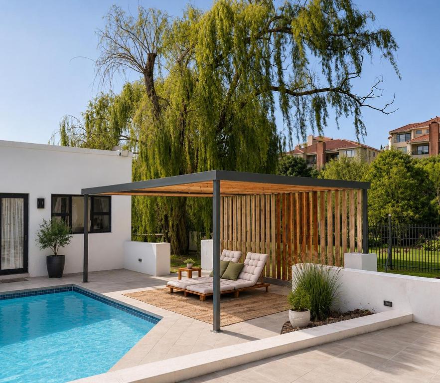a patio with a swimming pool and a pavilion at RiverfrontOasis - Huge Backyard, Pool, Grand Piano in Sandton