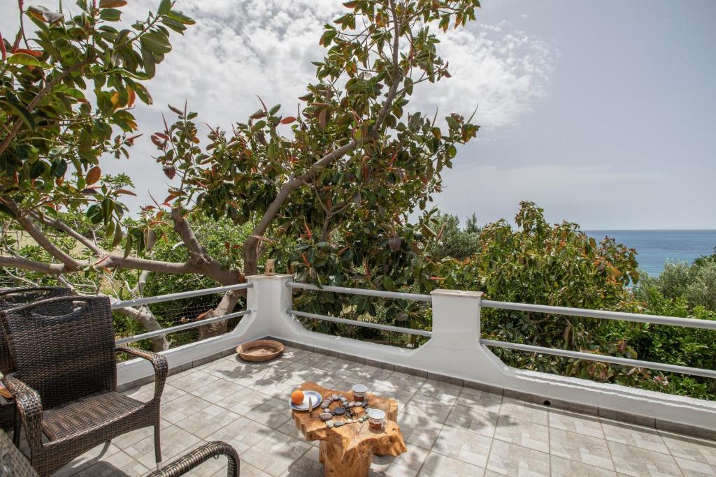 a balcony with a table and chairs and the ocean at Libyan Sea Sunset in Kerames