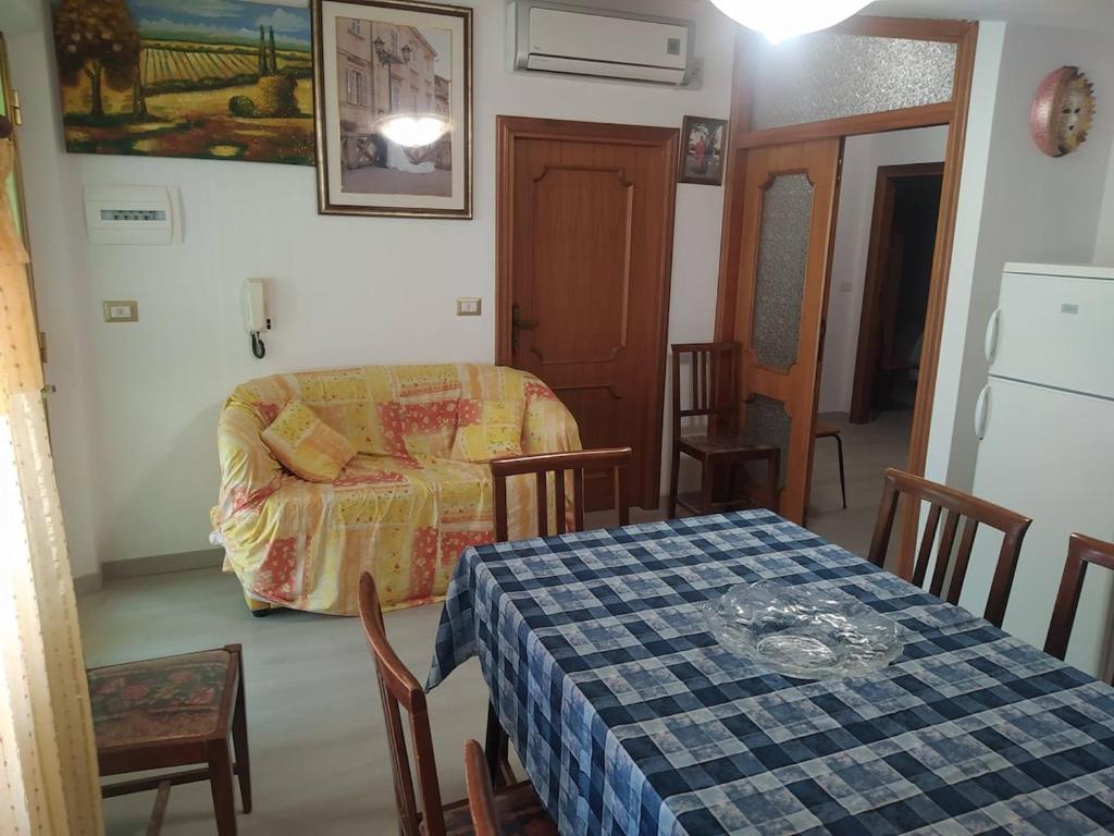 a living room with a table and a couch at La casa di Rosy in Alba Adriatica