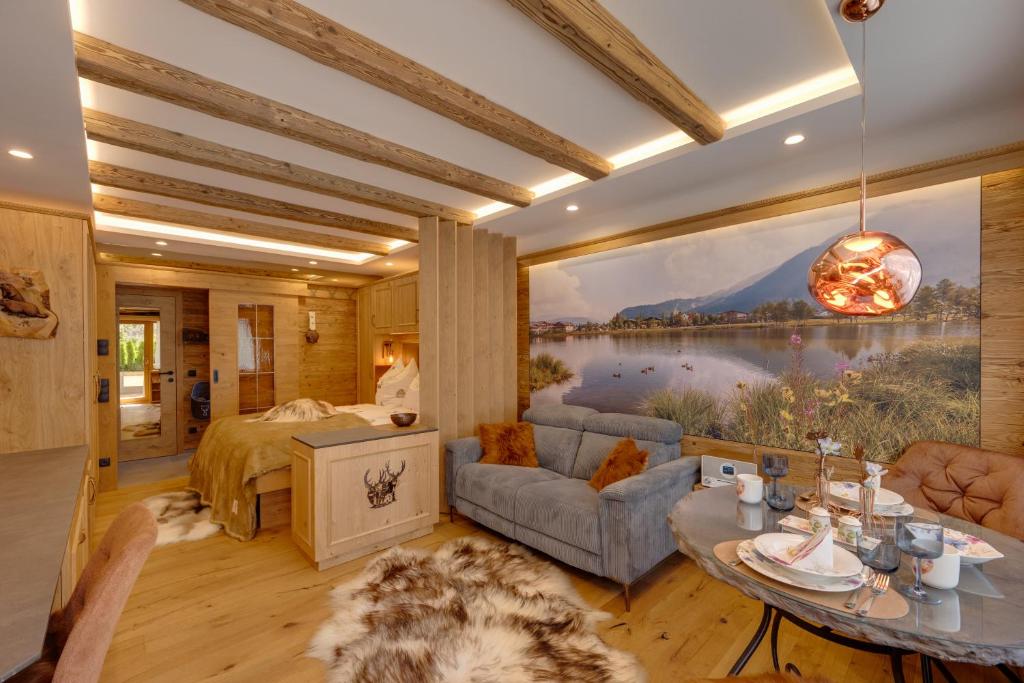 a bedroom with a large painting of a lake at Seefeld ALPIN Apartments in Seefeld in Tirol