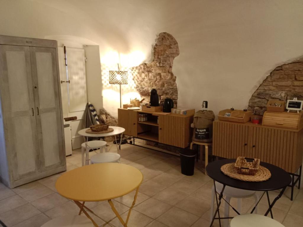 a living room with tables and chairs in a room at DEMIVIE GUESTHOUSE in Lerici