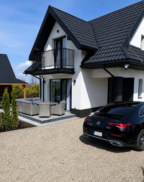 a black car parked in front of a house at Markowicz Alpine House in Szaflary