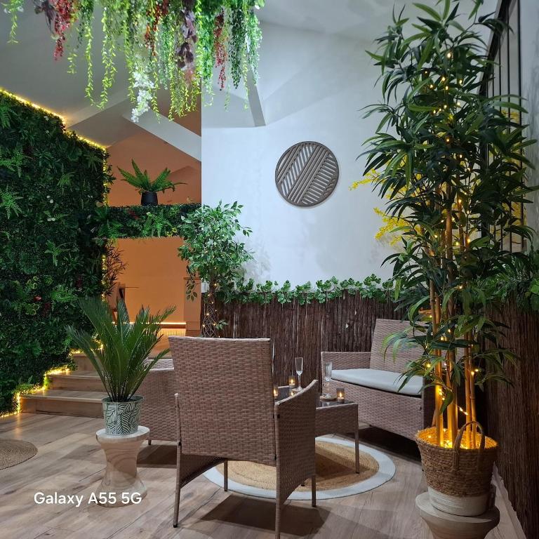a patio with chairs and plants in a building at Suite Canopée & Spa in Albi