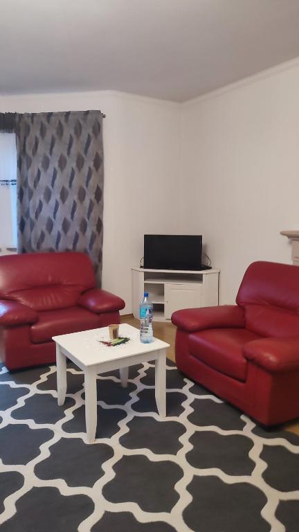 a living room with a red couch and a coffee table at Blue House 2 in Warsaw