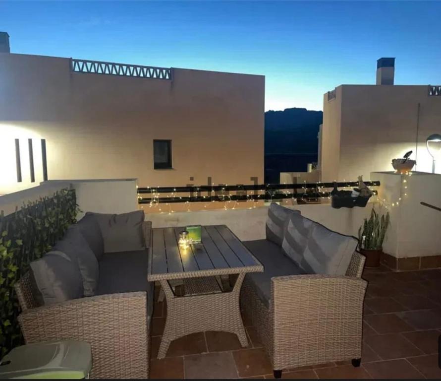 a patio with a table and chairs on a roof at Playa y Geoda, escapada perfecta in Pilar de Jaravía