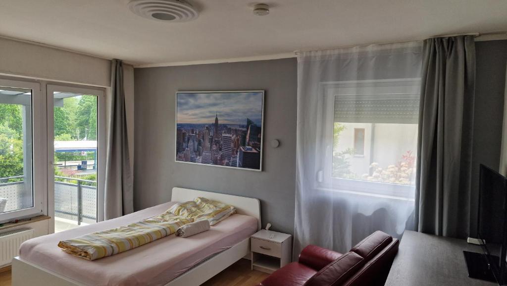 a bedroom with a bed and a window at Rooms & Apartments Schwäbisch Gmünd in Schwäbisch Gmünd