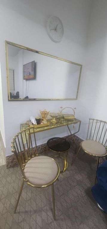 a room with a glass table and two chairs at الاردن - جرش in Jerash