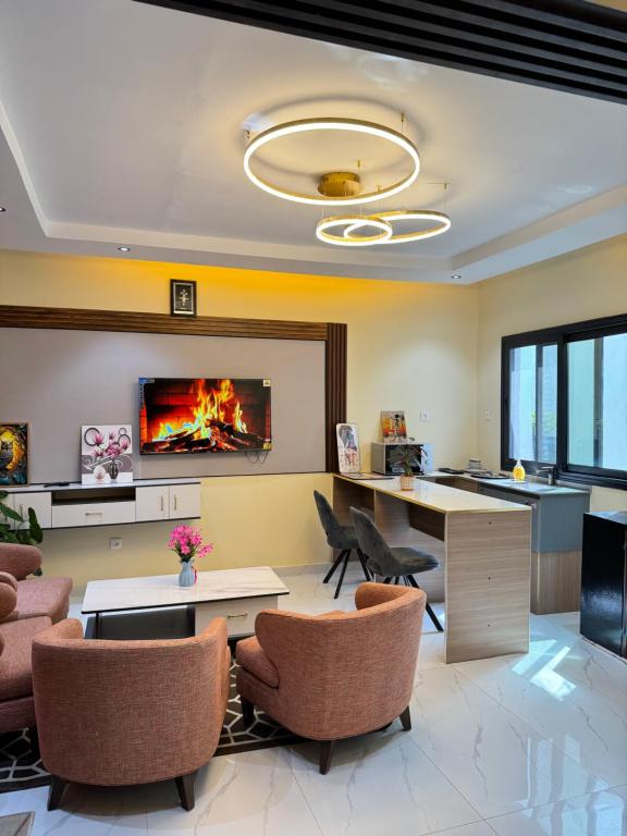 an office with a fireplace and a desk and chairs at Residence MBK Studio 1 in Ziguinchor