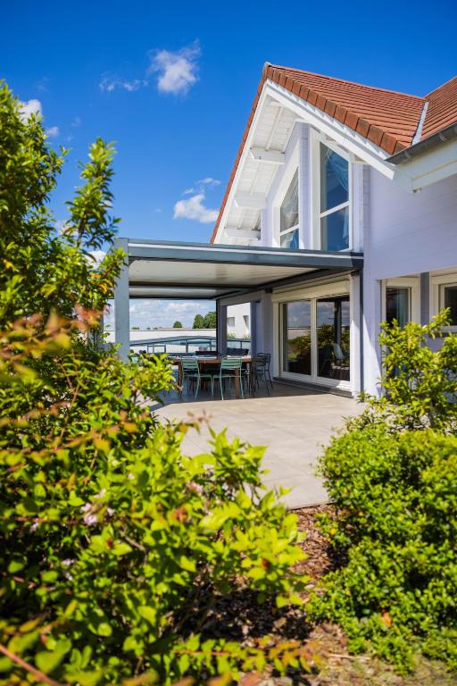 a house with a deck with a view of the ocean at Gite de Mortagne, Villa avec Piscine in Gigny-sur-Saône
