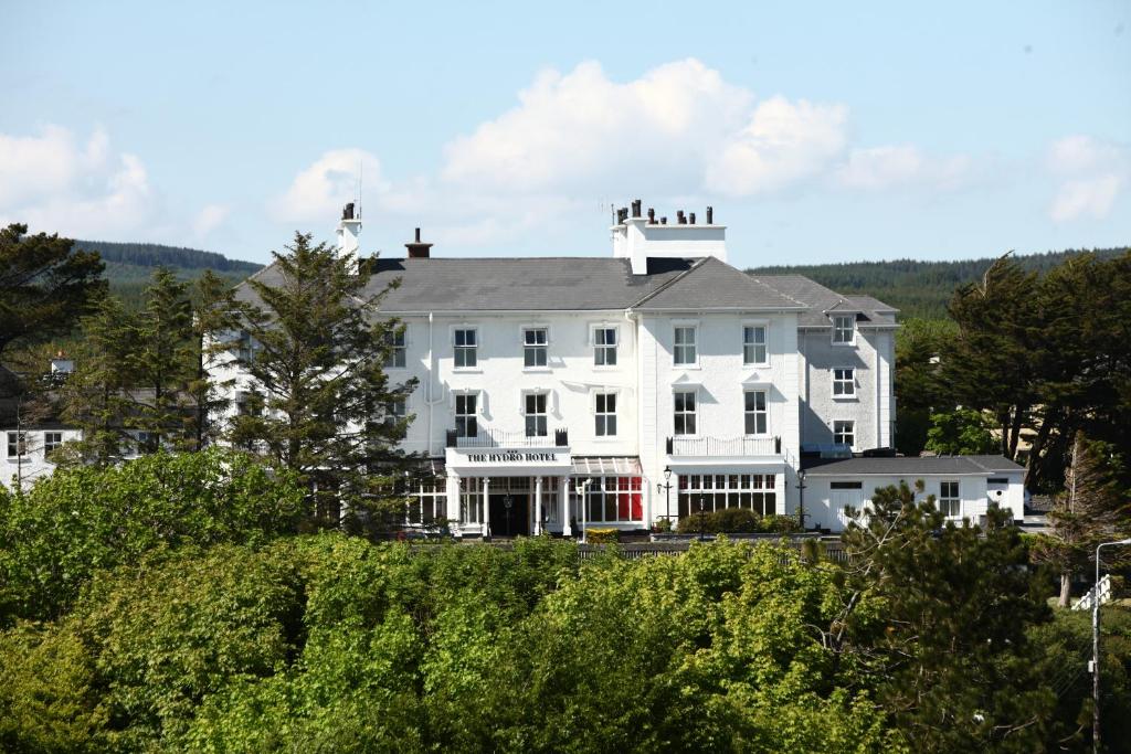 a large white building sitting on top of a hill at Hydro Hotel in Lisdoonvarna