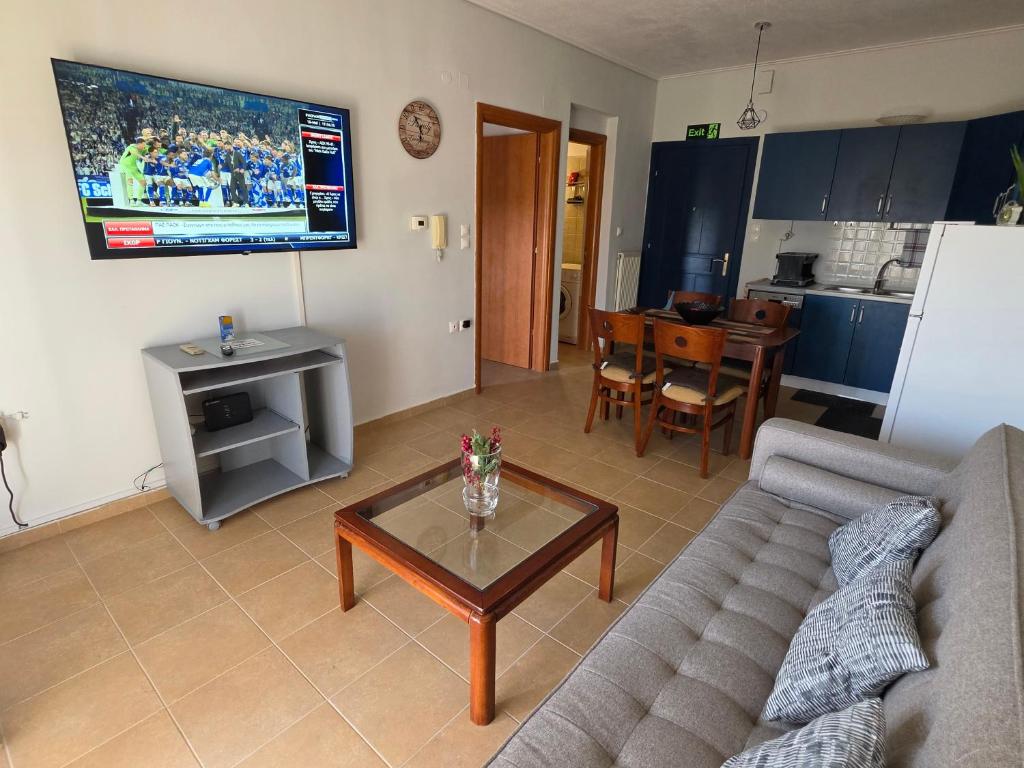 a living room with a couch and a table at Ippokratis 1 in Larisa