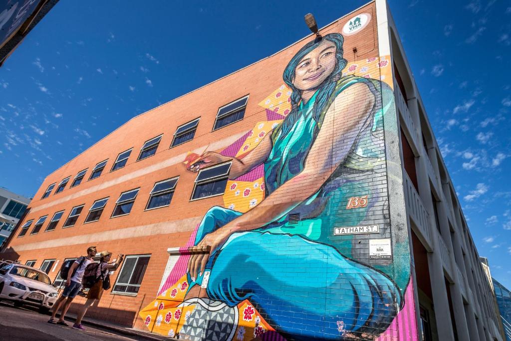 a mural of a woman on the side of a building at Adelaide Central YHA in Adelaide