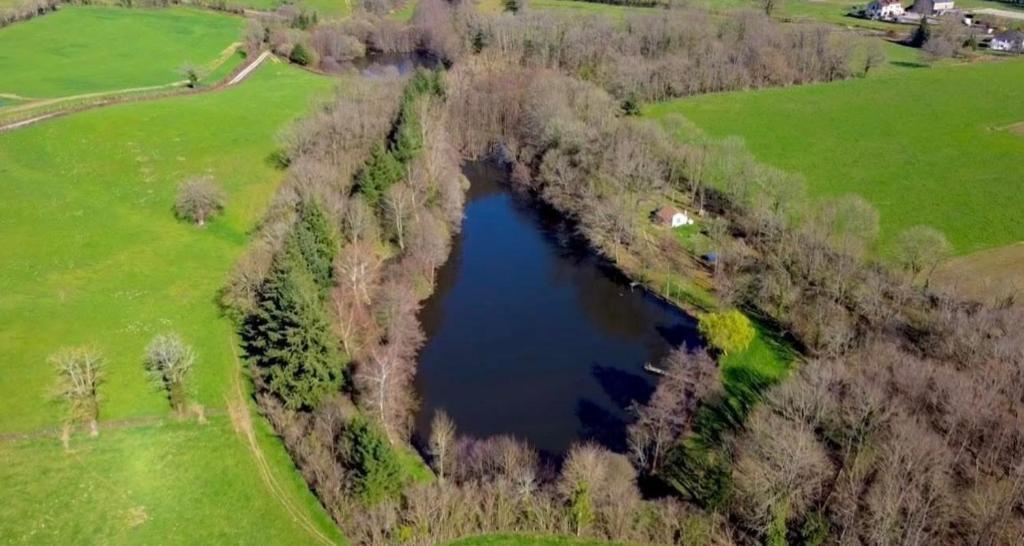 an aerial view of a lake in a field at Chalet Eden Insolite in Pionnat