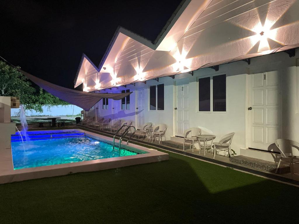 a house with a swimming pool at night at Impiani Chalet with Private Pool in Kuala Terengganu