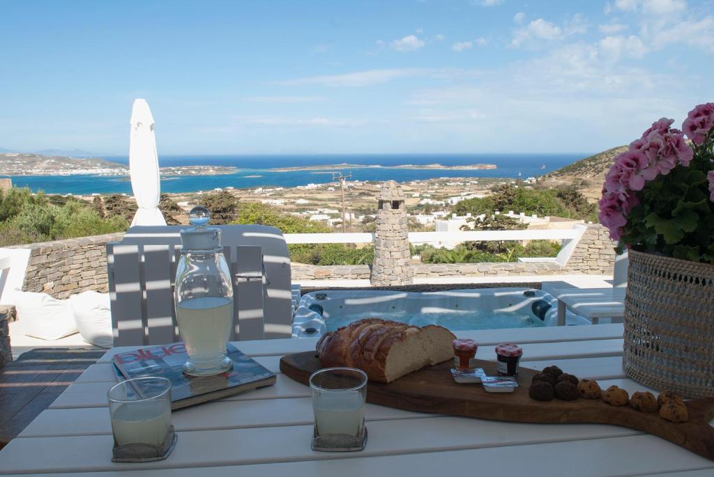 a table with bread and a bottle of water and a view at Chrysalis Nature Villa 4 in Kampos Paros