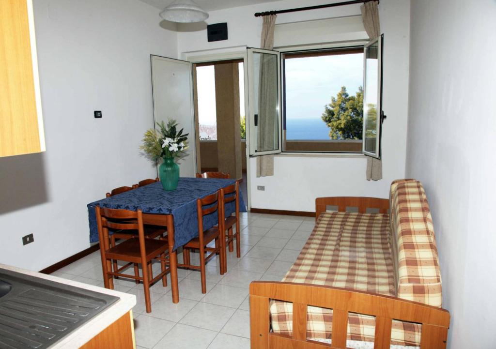 a dining room with a blue table and chairs at Club Residence Tropea Pace in Tropea