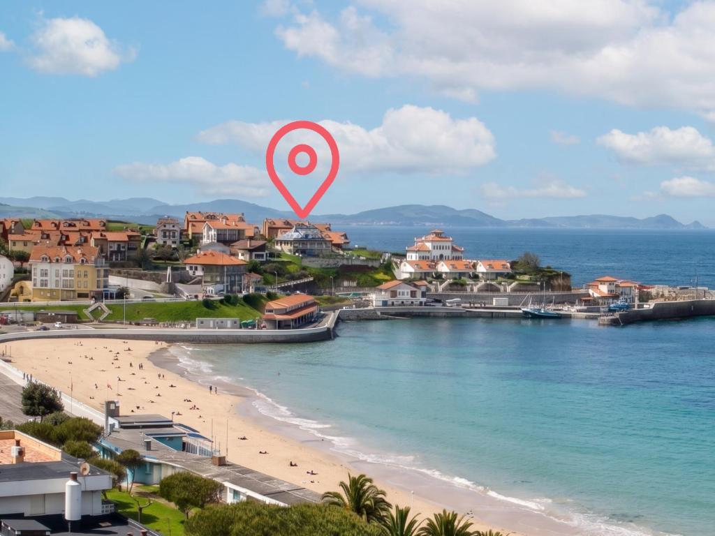 a view of a beach with a red marker at Casa del Muelle COMILLAS in Comillas