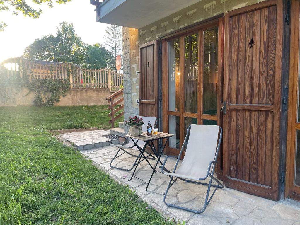 a table and two chairs sitting on a patio at Nùi Homestay in Monastero di Lanzo