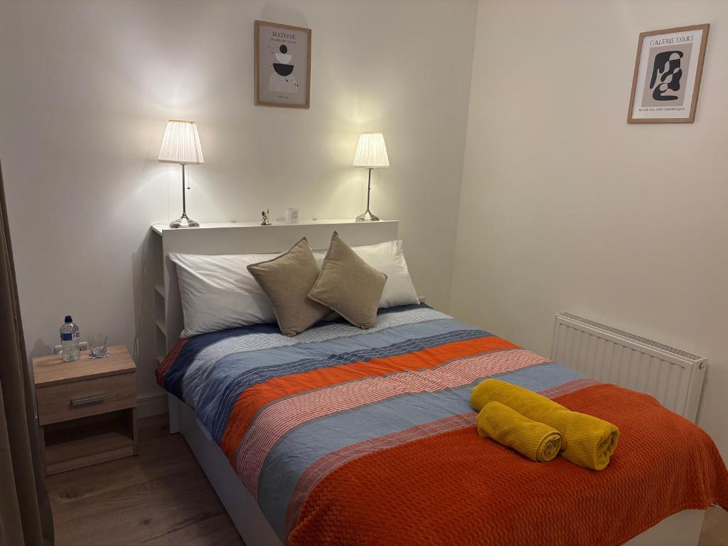 a bedroom with a bed with two towels on it at La Vio Homestay Private Room & Bathroom, Newcastle Dublin in Newcastle