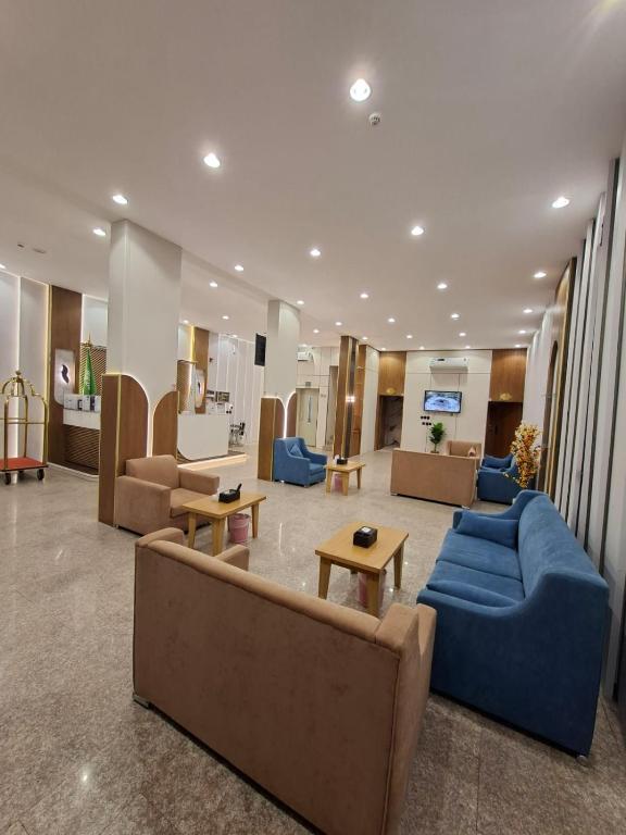 a lobby with couches and tables in a building at راحتي ستار للشقق المخدومة in Ukaz