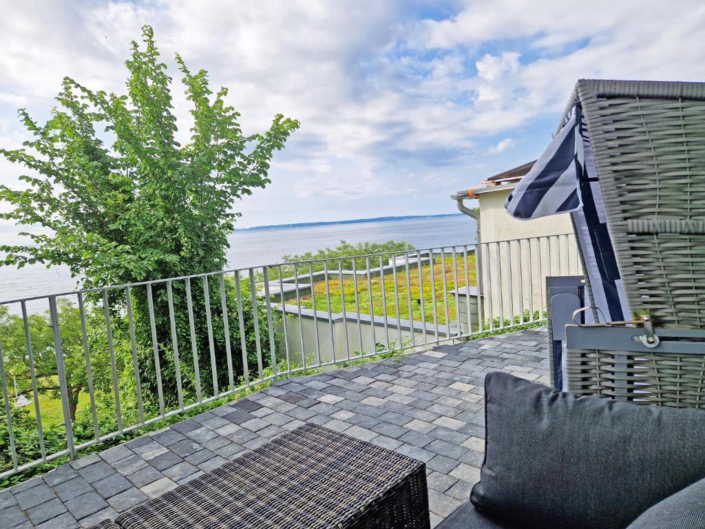 a balcony with a view of the water at Villa Küstenperle, Meerblick-Appartements in Sassnitz