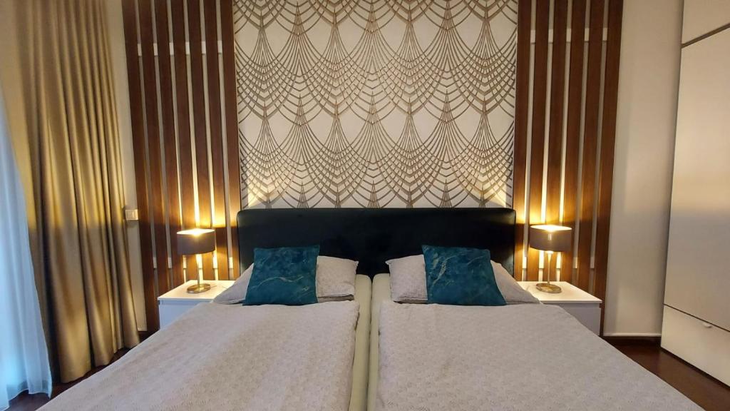 a bedroom with a large bed with two pillows at Apartment Moser 1303 in Karlovy Vary