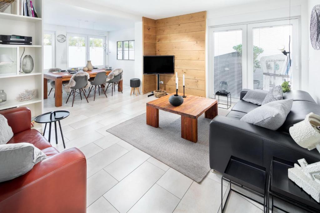 a living room with a couch and a table at Seehaus 48 in Norderney