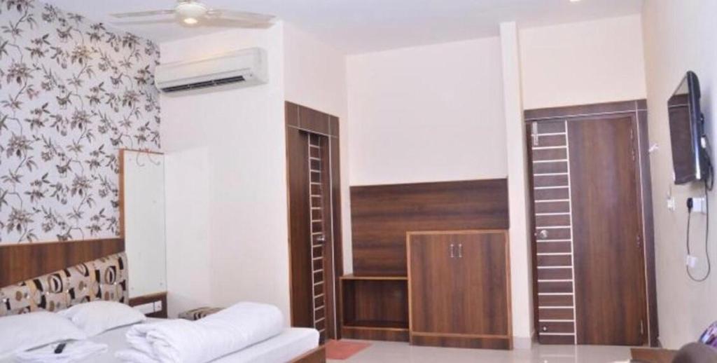 a living room with a bed and a sliding glass door at Hotel Rama palace in Mathura