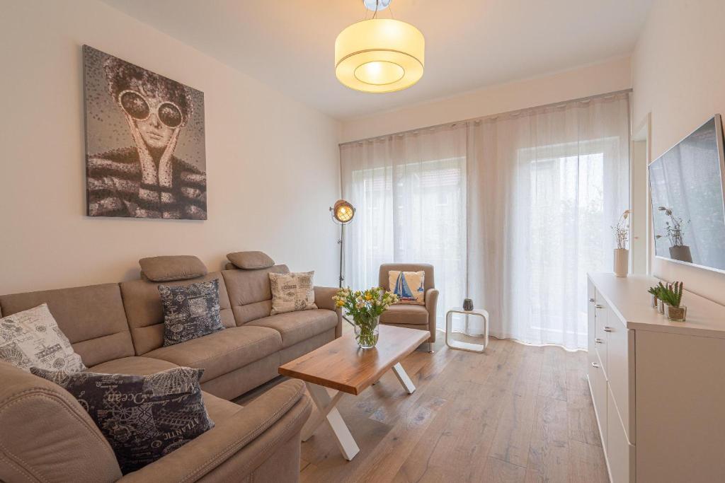 a living room with a couch and a table at Meergenuss in Norderney