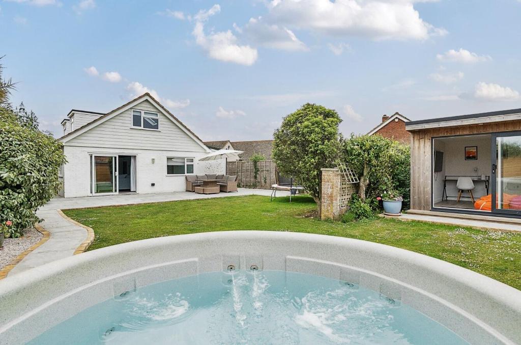 a swimming pool in the backyard of a house at Number Twenty Four in West Wittering