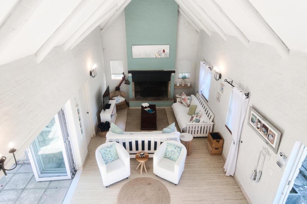 an overhead view of a living room with white furniture at Seafever in Arniston in Arniston