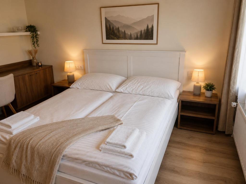 a bedroom with a white bed with two towels on it at Alpine Studio near Bad Ischl#2 in Haiden