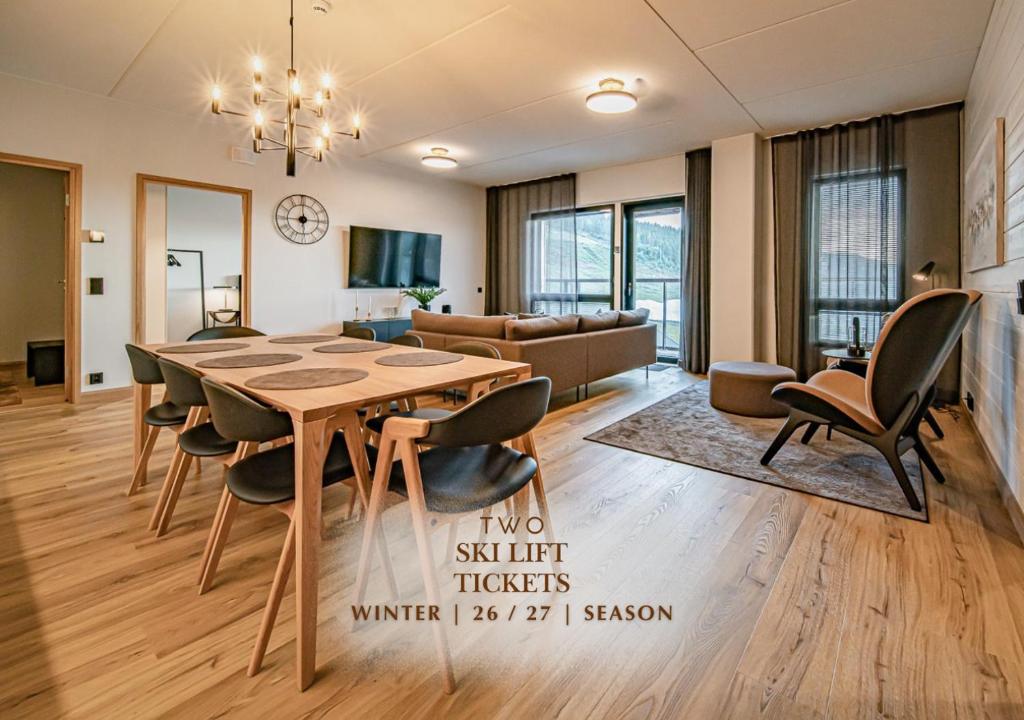 a dining room with a table and chairs and a couch at Ski Chalet C27 Levi Center incl 2 ski passes by Aavalevi in Levi