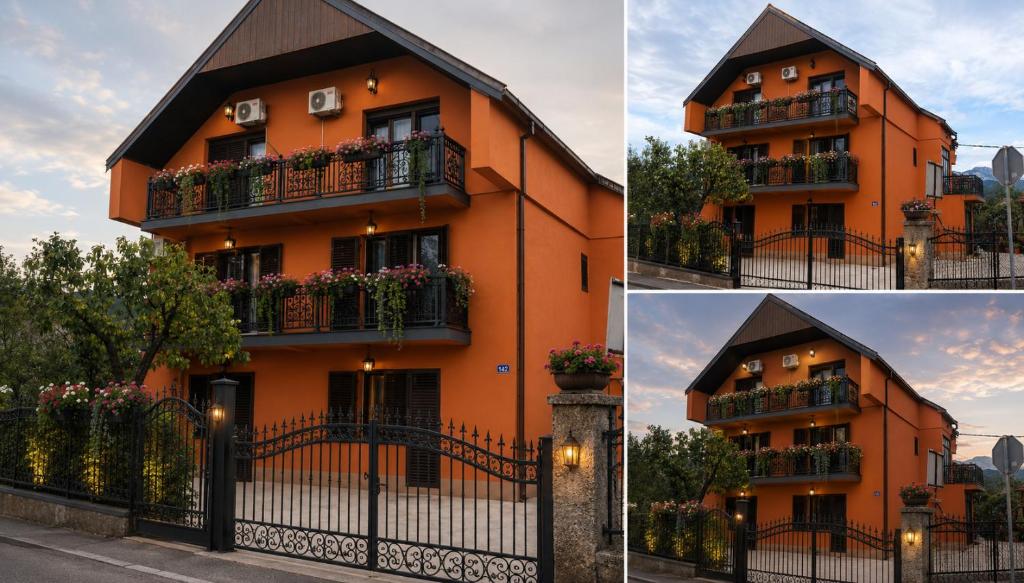 a orange building with balconies and a fence at Honey House Martinovic in Cetinje