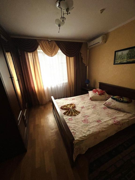 a bedroom with a large bed with a window at готель Славутчанка in Slavuta
