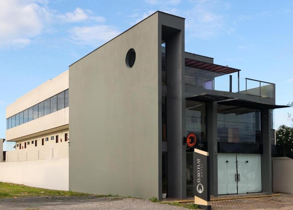 a large white building with a large window at Euro Flat Hotel in Parnaíba