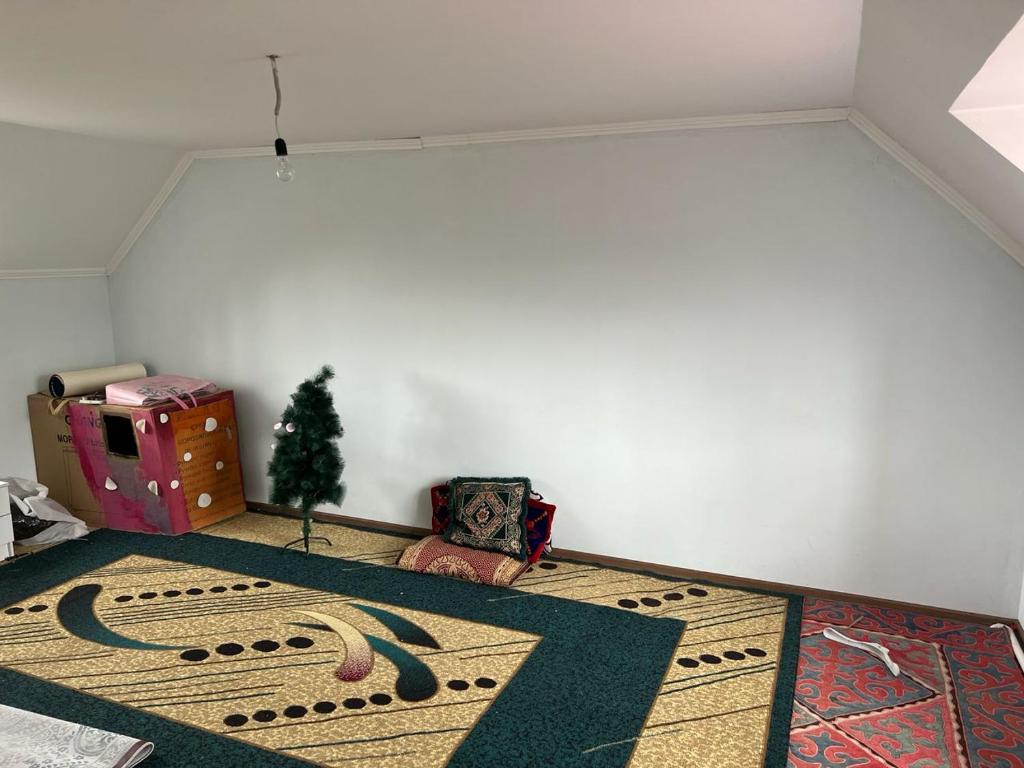 a living room with a rug on the floor at Aimir in Akchiy