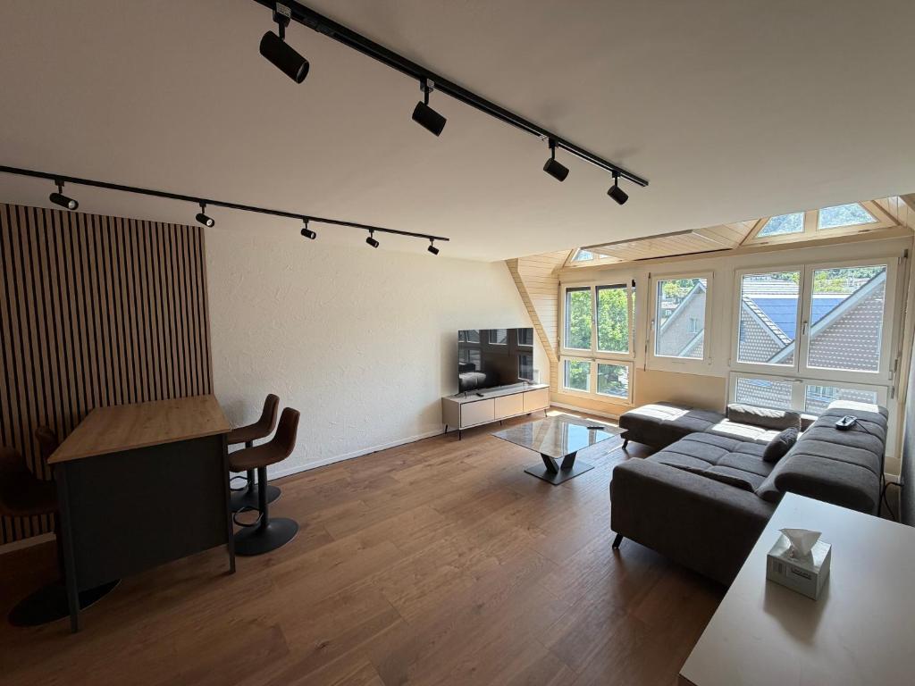 a living room with a couch and a table at City Apartments in Brunnen