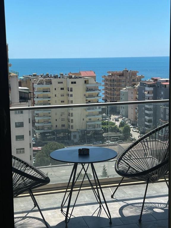 a table and two chairs on a balcony with a view at Sea View Apartments in Durrës