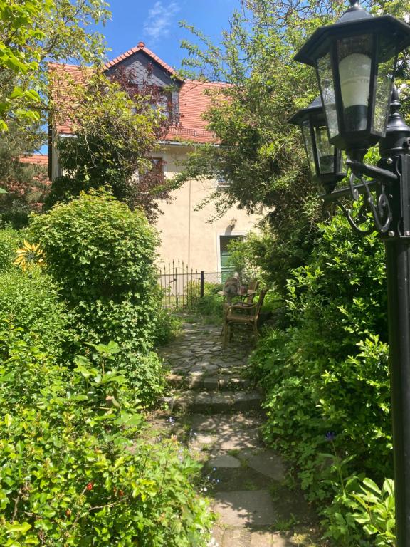 a path leading to a house with a street light at Ferienwohnung Haubitz in Borna