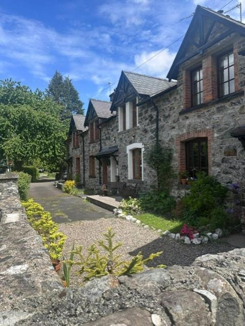 a large stone house with a stone path in front at Bwythyn Ebrill, April Cottage in Betws-y-coed