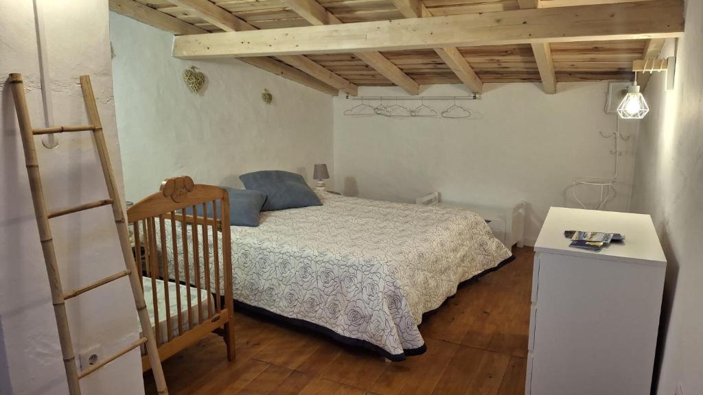 a small bedroom with a bed and a ladder at A Casinha in Portel