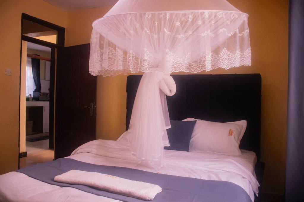 a bedroom with a bed with a veil hanging over it at Cisa Homes in Gatunga