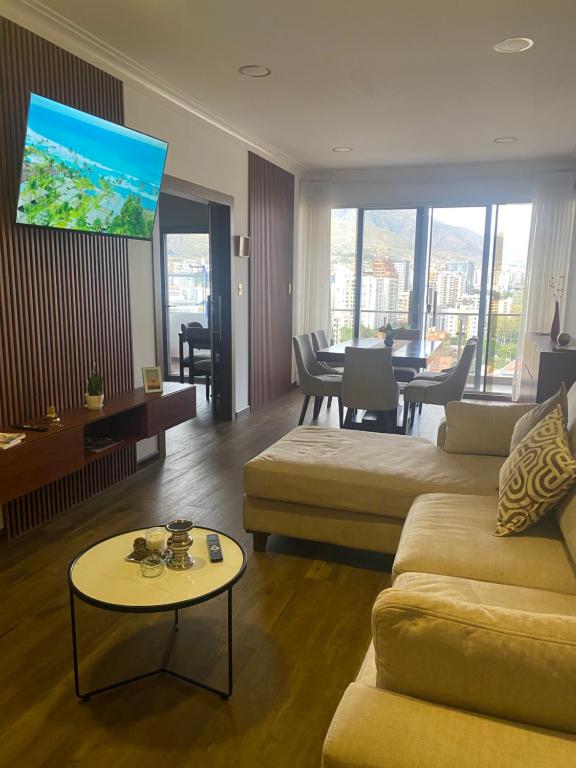 a living room with a couch and a table at Apartamento céntrico y lujoso in Cochabamba